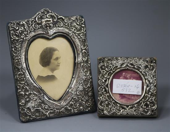 Two early 20th century repousse silver mounted photograph frames, one with heart shaped aperture, largest 19.4cm.